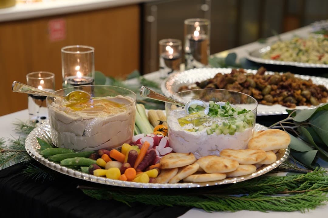 Catered buffet styled with greenery and candlelight by Just Party Co.