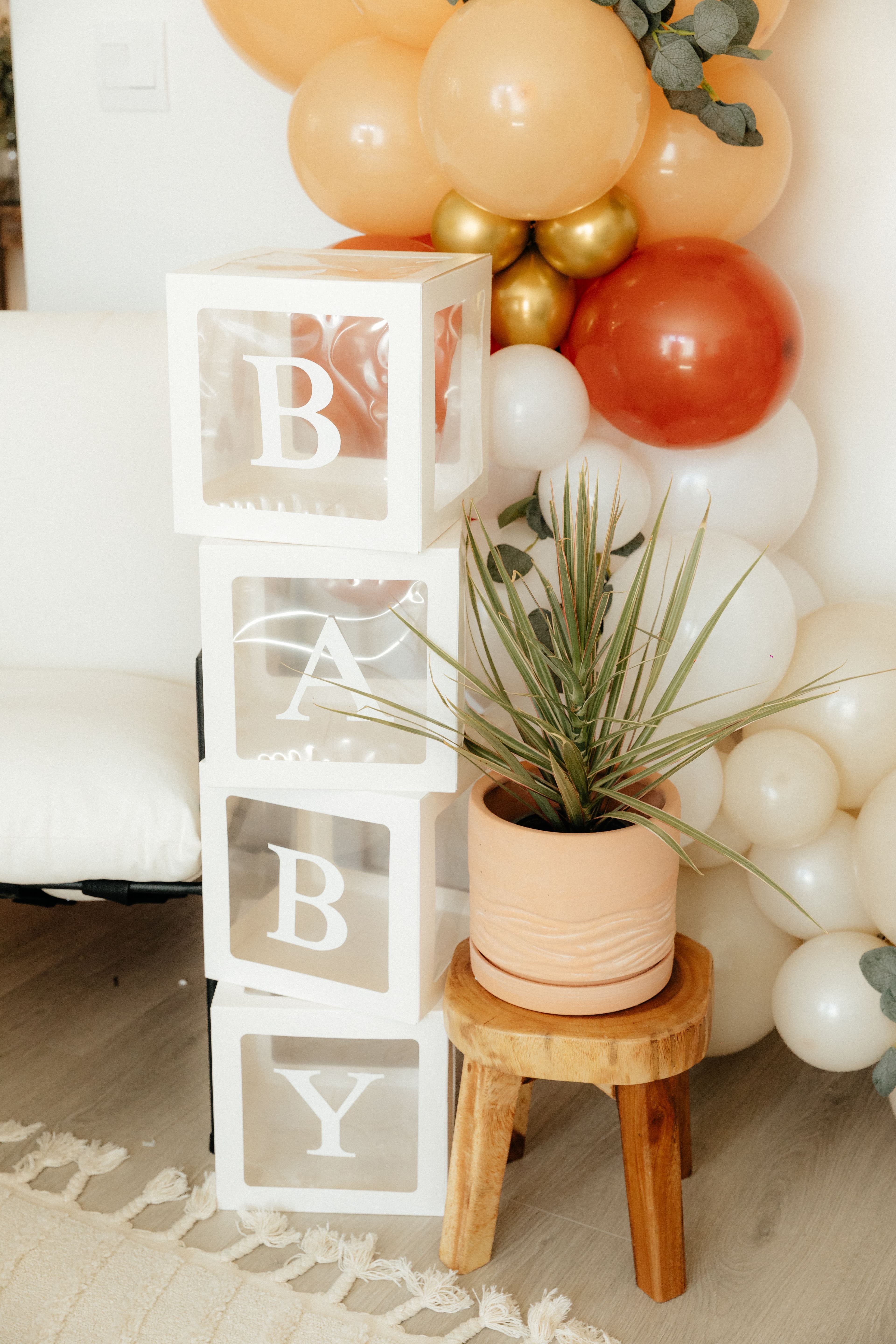 Neutral baby shower décor with balloons and decorative blocks
